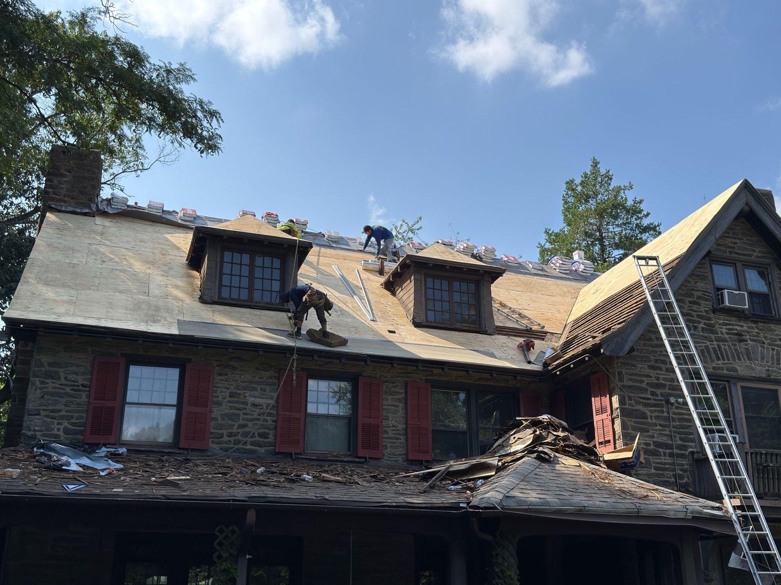 Before — old wooden shingles being stripped